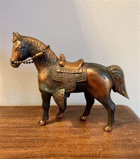 The size is ideal to tuck into bookshelves. . Antique horse figurines